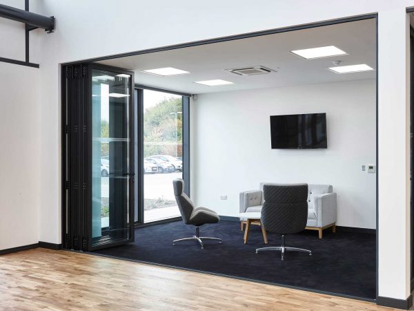 Waiting room space with two chairs and a sofa